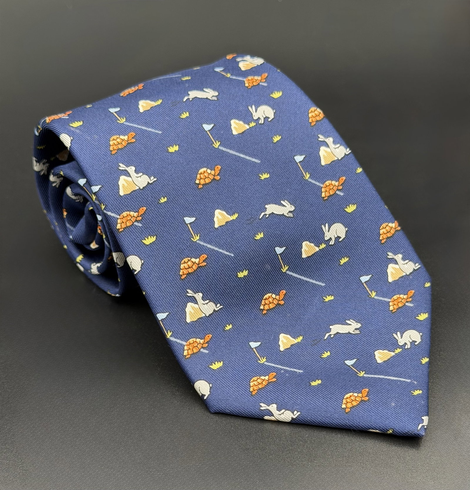 MSRP $395 HERMÈS Paris Navy Blue Tortoise & Hare Golf Motif 100% Silk Twill Necktie (Unau: PLEASE READ: This item has not been authenticated by Atomic Pear. Please ask absolutely any questions or request additional photographs before you bid. Thank you! Love, Atomic Pear Offered is a whimsi