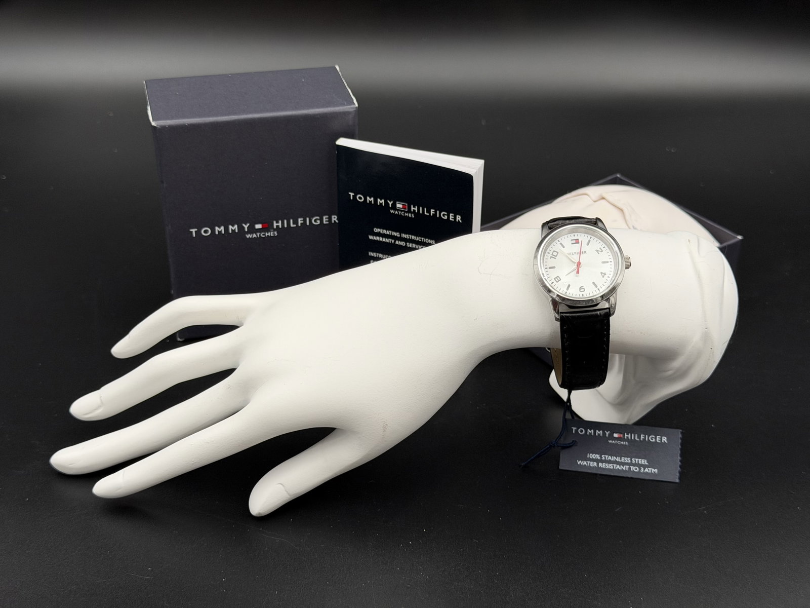 MSRP $125 Tommy Hilfiger Silver-Tone Classic White Dial Quartz Watch Box Set: Offered is a classic Tommy Hilfiger quartz watch featuring a clean white sunray dial accented by bold alternating numeral and stick indices, a prominent red second hand, and the iconic Hilfiger flag l