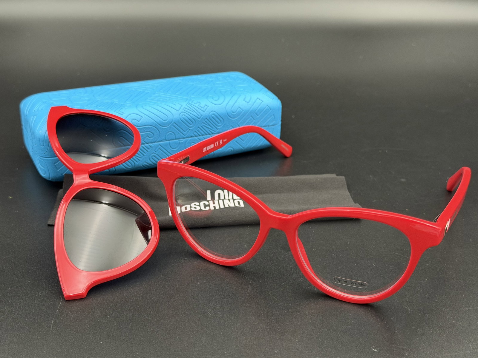 MSRP $450 Love Moschino MOL051/CS Red Cat Eye Eyeglasses 52mm Magnetic Clip-On NWOT w/ Case: Add a playful designer touch to your eyewear collection with these Love Moschino MOL051/CS eyeglasses. Crafted in a vibrant red finish, these cat-eye frames feature the signature Love Moschino heart d