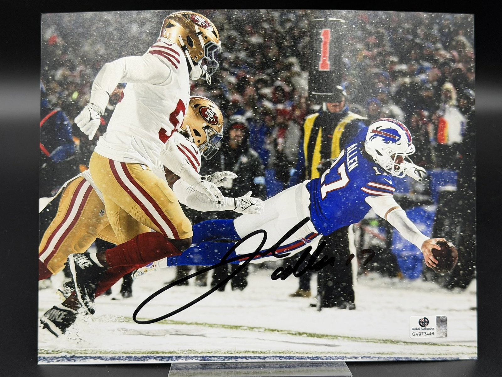 JOSH ALLEN – Buffalo Bills "Snow Game Super Dive" Autographed 8" × 10" Photograph &ndash: An exceptional sports collectible: a dynamic, hand–signed 8" × 10" photograph of Buffalo Bills superstar quarterback Josh Allen, capturing one of the most iconic moments in modern NFL hist