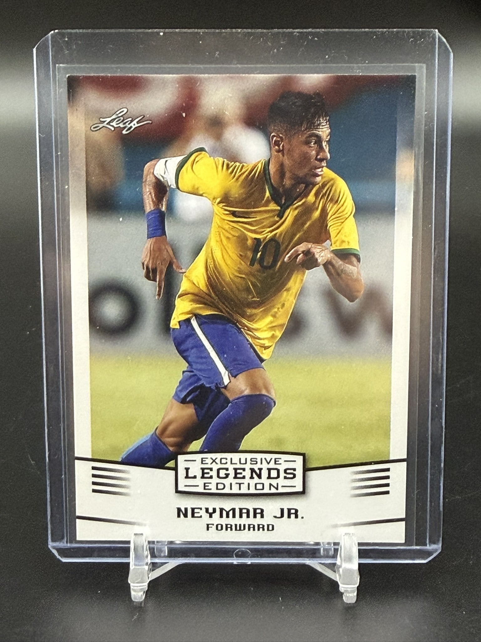 2016 Leaf Exclusive Legends Edition Neymar Jr. Brazil Soccer Card #06: 2016 Leaf Exclusive Legends Edition trading card featuring Neymar Jr. in Brazil's iconic yellow national team kit. This collectible captures one of Brazil's greatest modern footballers during the prim