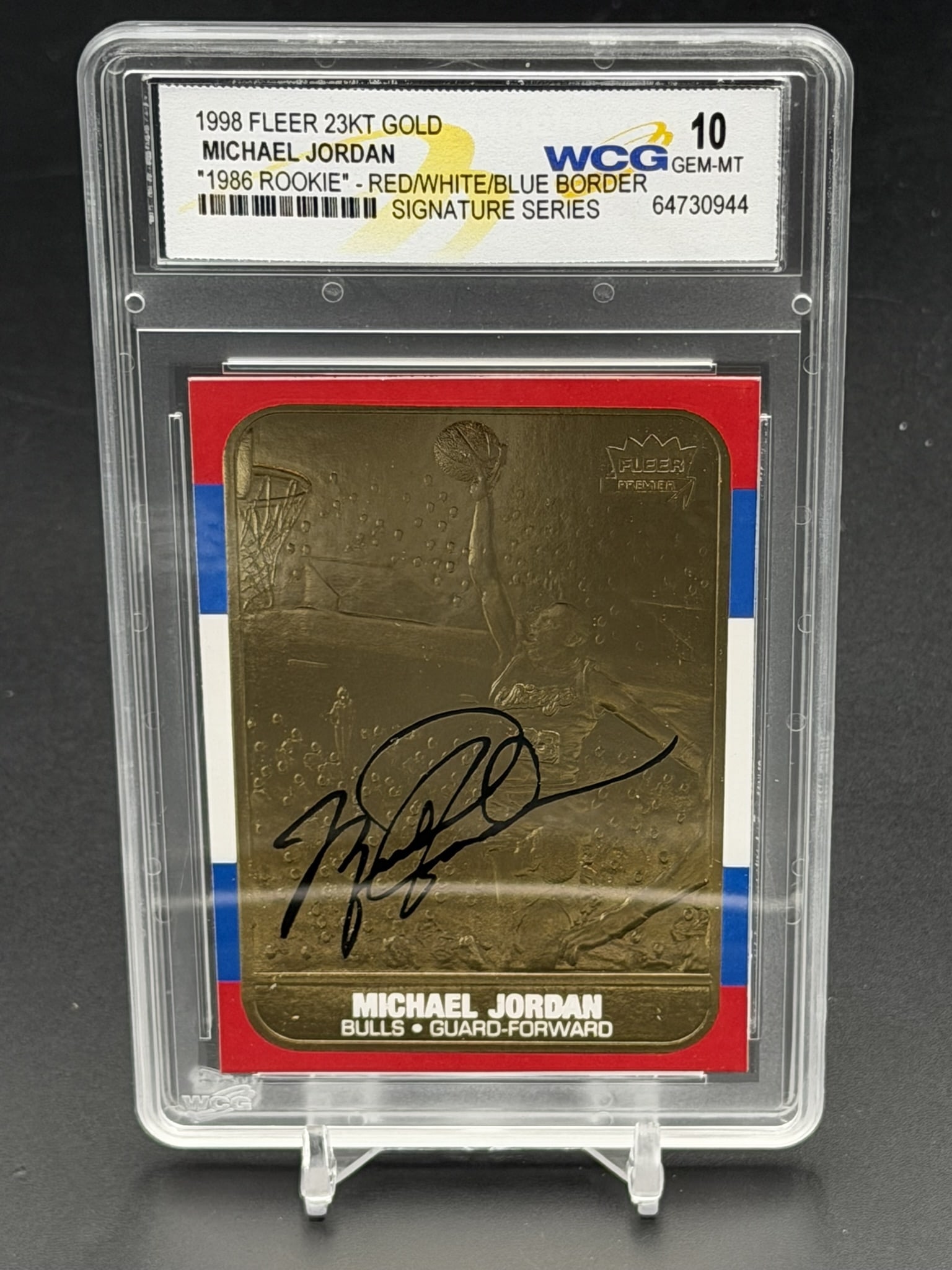 1998 Fleer 23KT Gold Michael Jordan 1986 Rookie Red White Blue Border WCG 10 Signature Series: 1998 Fleer 23KT Gold Michael Jordan Signature Series card, professionally graded WCG Gem-MT 10. This premium metallic collectible pays tribute to his iconic 1986 rookie design, featuring a sculpted go