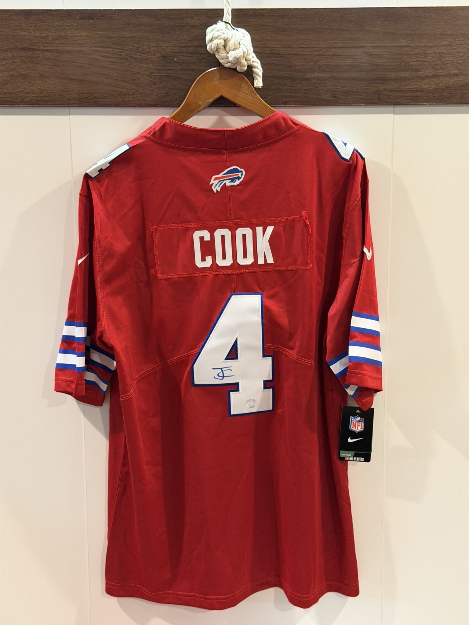 James Cook Signed Buffalo Bills Alternate Jersey – KB COA: A Buffalo Bills alternate red Nike jersey signed by running back James Cook across the back numerals. The vibrant team colorway enhances display presence, while the autograph marks the ascent of one o