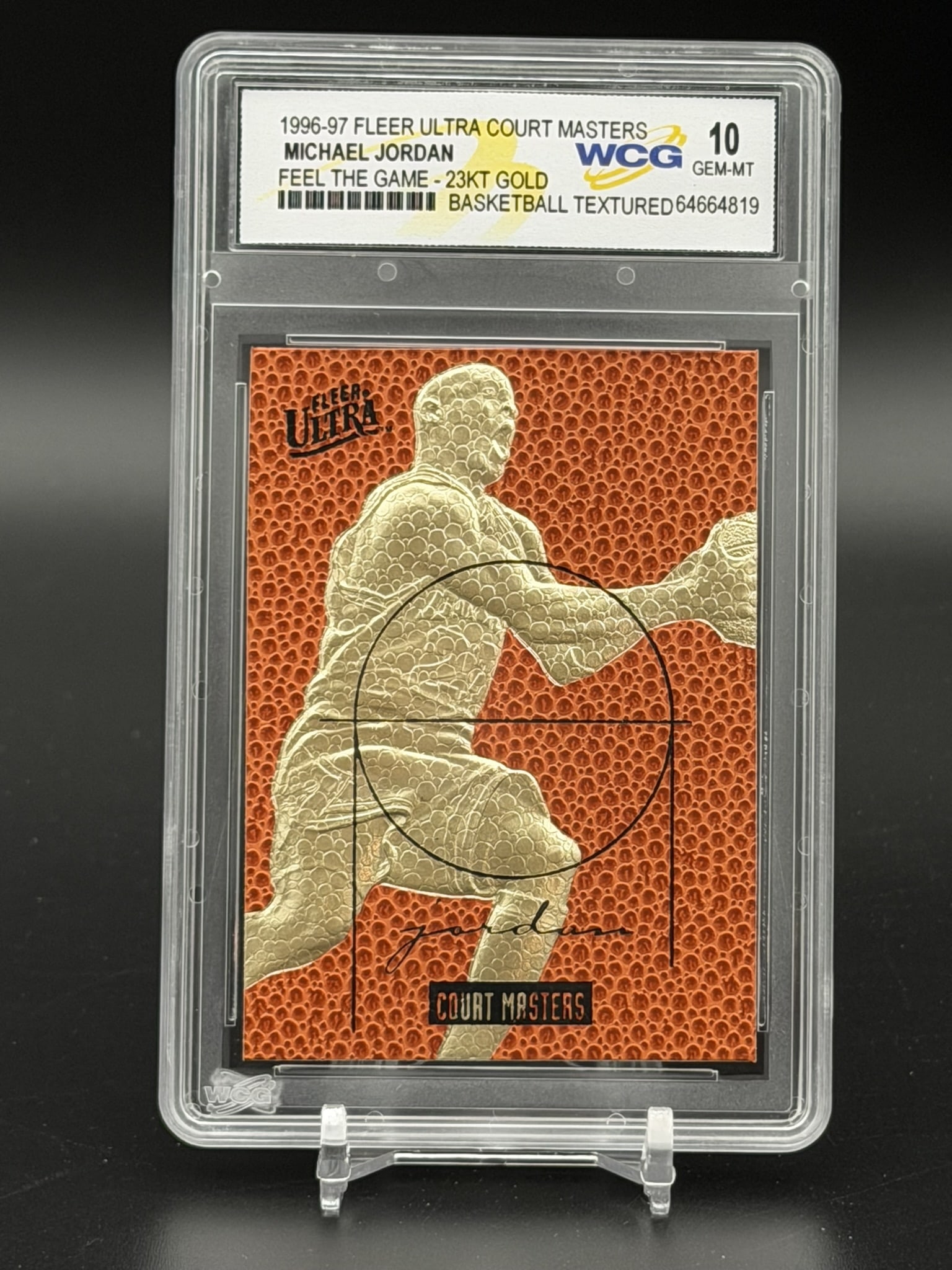 1996-97 Fleer Ultra Court Masters Michael Jordan 23KT Gold Feel The Game WCG 10 Basketball Card: An exceptional sports collectible: a pristine WCG GEM MINT 10 example of Michael Jordan’s 1996–97 Fleer Ultra Court Masters "Feel The Game" 23KT gold commemorative. The composition feature
