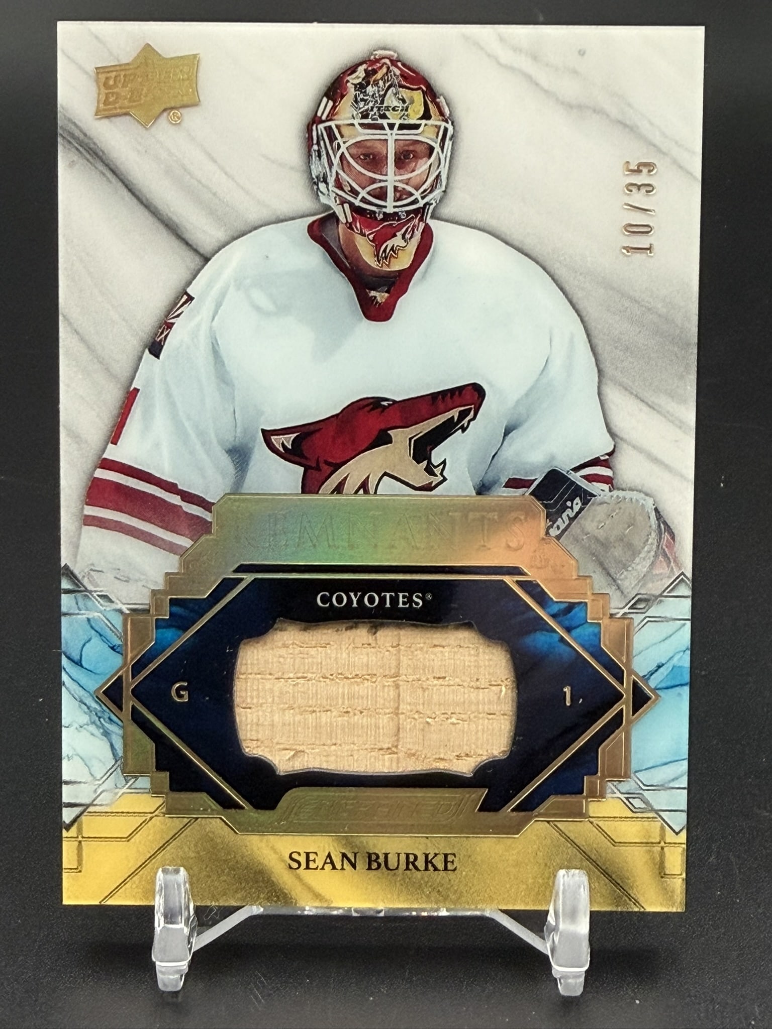 Sean Burke 2019-20 Upper Deck Engrained Remnants Gold #R-SB Game-Used Jersey 10/35: Official 2019-20 Upper Deck Engrained Hockey Remnants Gold memorabilia card featuring Sean Burke. This premium insert contains an authentic game-used jersey relic certified by Upper Deck as having bee