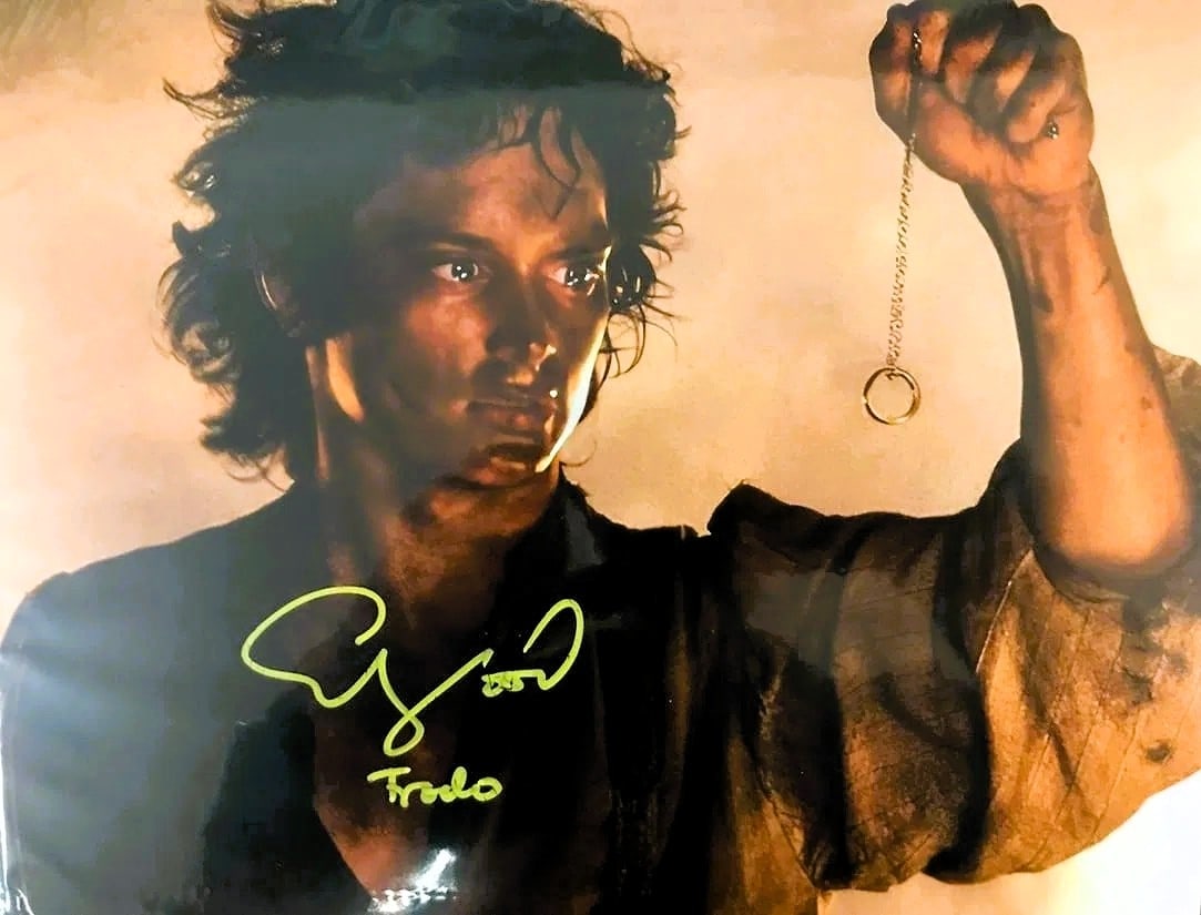 Elijah Wood Signed and Inscribed The Lord of the Rings Photo 8"x10" WWOC COA: Elijah Wood signed and Inscribed The Lord of the Rings 8x10 photo. Signature appears on the photo (yellow ink). Accompanied by WWOC authentication. Highlights Elijah Wood autograph and inscription on 