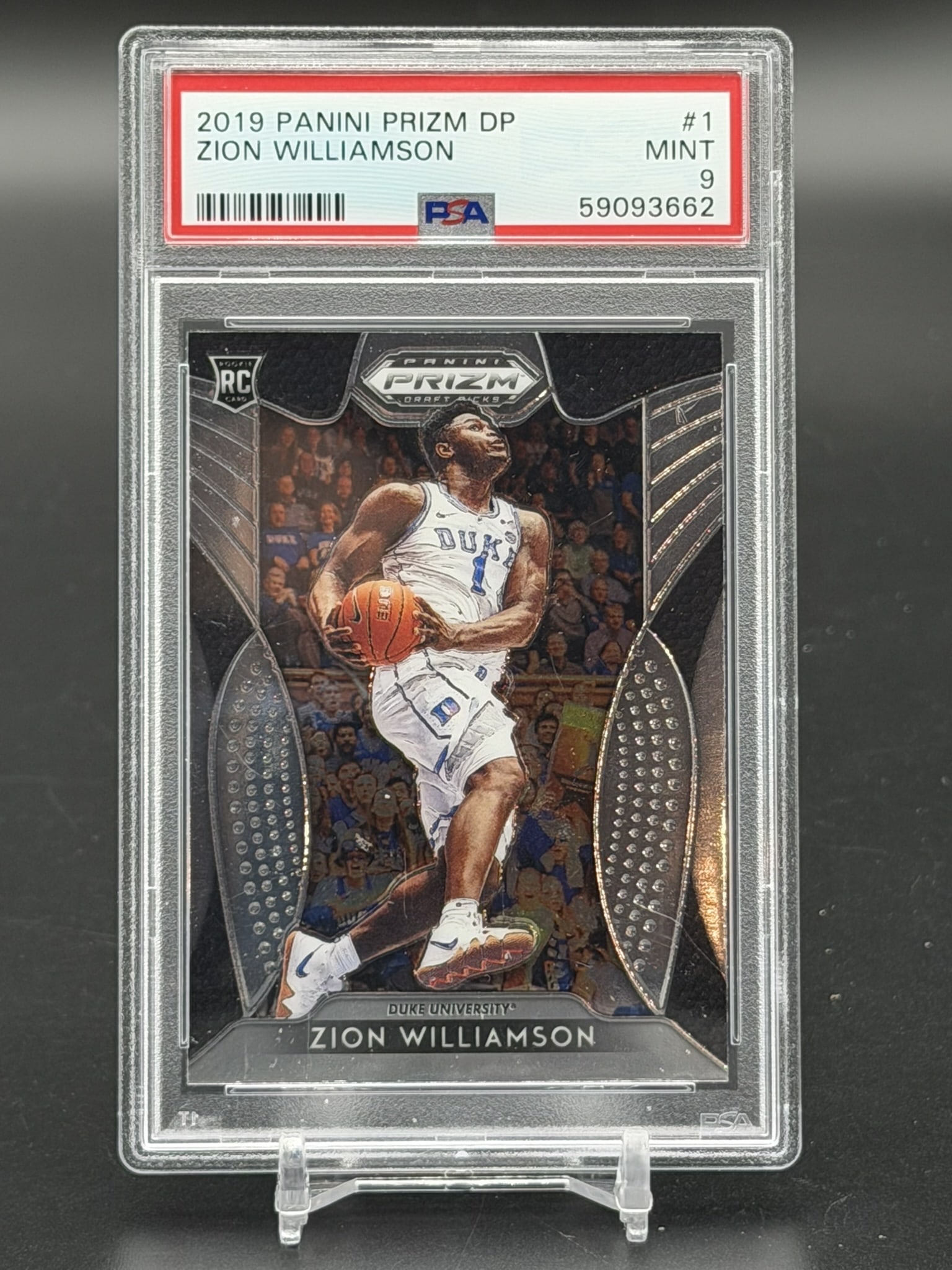 2019 Panini Prizm Draft Picks Zion Williamson RC #1 PSA 9 Mint Duke University Rookie Card: 2019 Panini Prizm Draft Picks Zion Williamson Rookie Card #1, professionally graded PSA Mint 9. This officially licensed rookie-year card features the forward during his collegiate career with the Duk