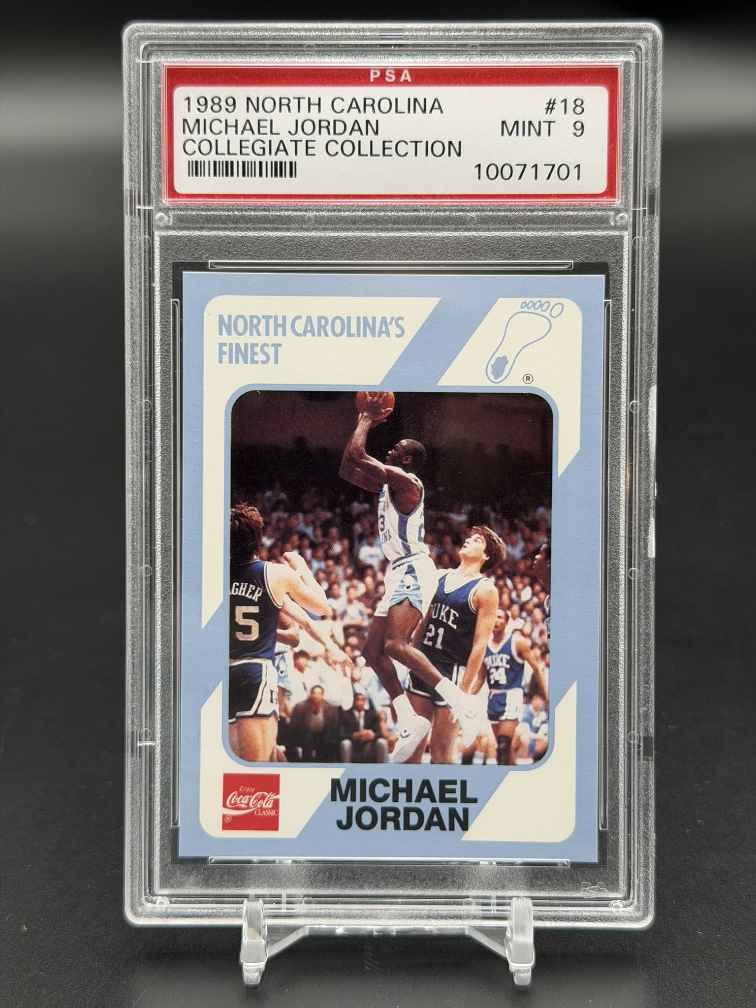 1989 Collegiate Collection Michael Jordan North Carolina Finest #18 PSA 9 Mint Tar Heels Card: Vintage 1989 Collegiate Collection Michael Jordan North Carolina's Finest card #18, professionally graded PSA Mint 9. The front of this card features a collegiate action photograph of Jordan shooting 