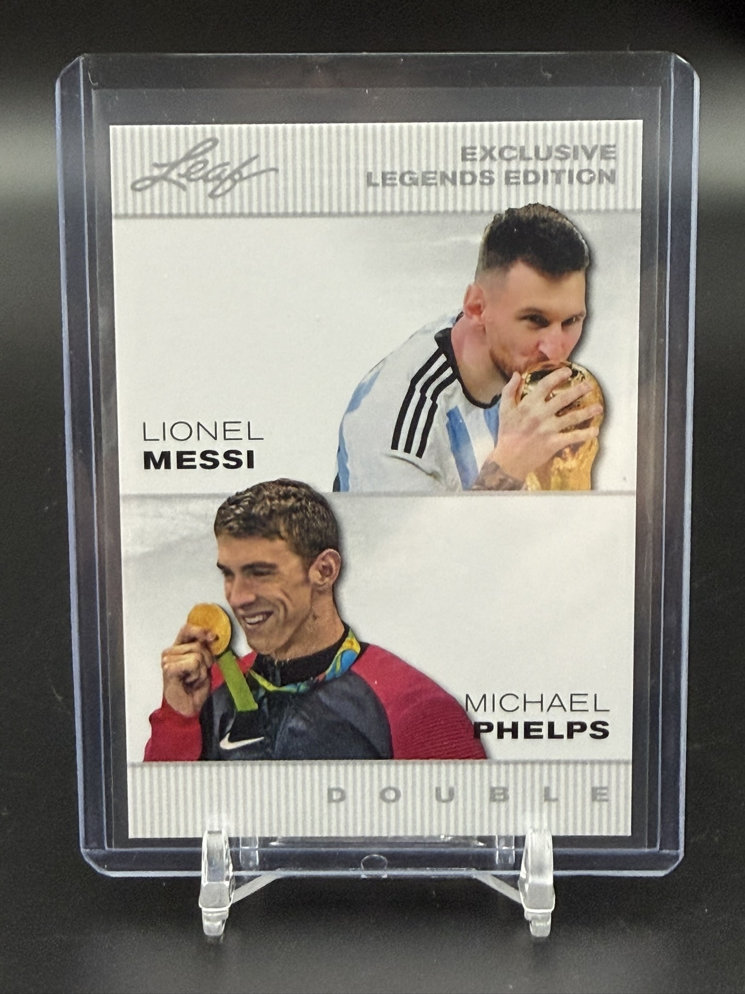 2024 Leaf Exclusive Legends Edition Double Lionel Messi Michael Phelps Card ELE-26: 2024 Leaf Exclusive Legends Edition Double card featuring two of the greatest champions in sports history, Lionel Messi and Michael Phelps. This unique crossover collectible pairs Messi celebrating Ar