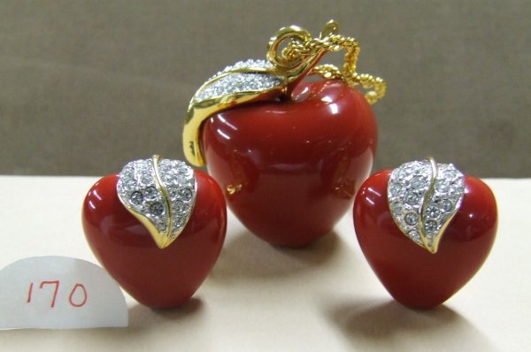 Kenneth Jay Lane Apple Necklace Set: Resin apple pendant with a rhinestone leaf on 34" gold-tone chain with matching clip-on earrings.