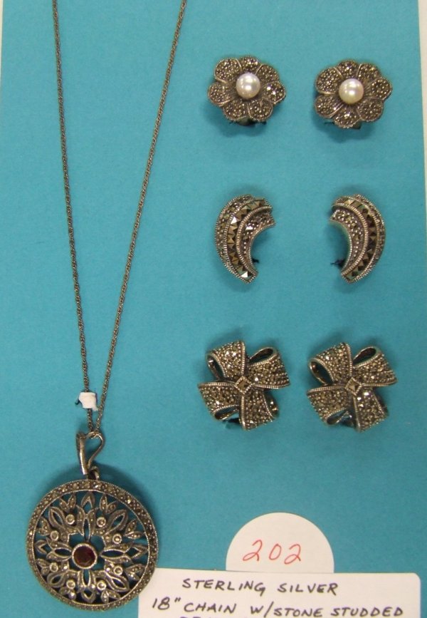 Sterling Silver Marcasite Collection : Collection includes an 18" chain with stone and marcasite studded round pendant and 3 pair marcasite studded clip-on earrings; all sterling silver. 1.25 TTOW with stones.