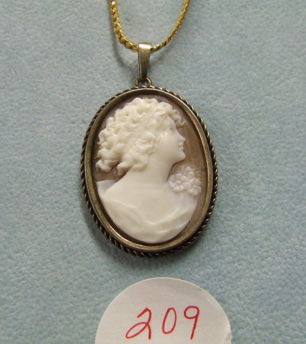 Cameo Pendant Necklace: 28" Gold-tone Monet chain features a lovely real shell cameo pendant. This is an older vintage cameo with a hairline in the shell.