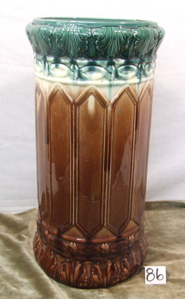 Brush Pottery 21" Umbrella Jar: Impressive 21" tall umbrella stand is in green, cream, and brown high glaze. Stand has multiple small rim chips and a large underside chip, but overall displays well. Pick-up only on this piece.