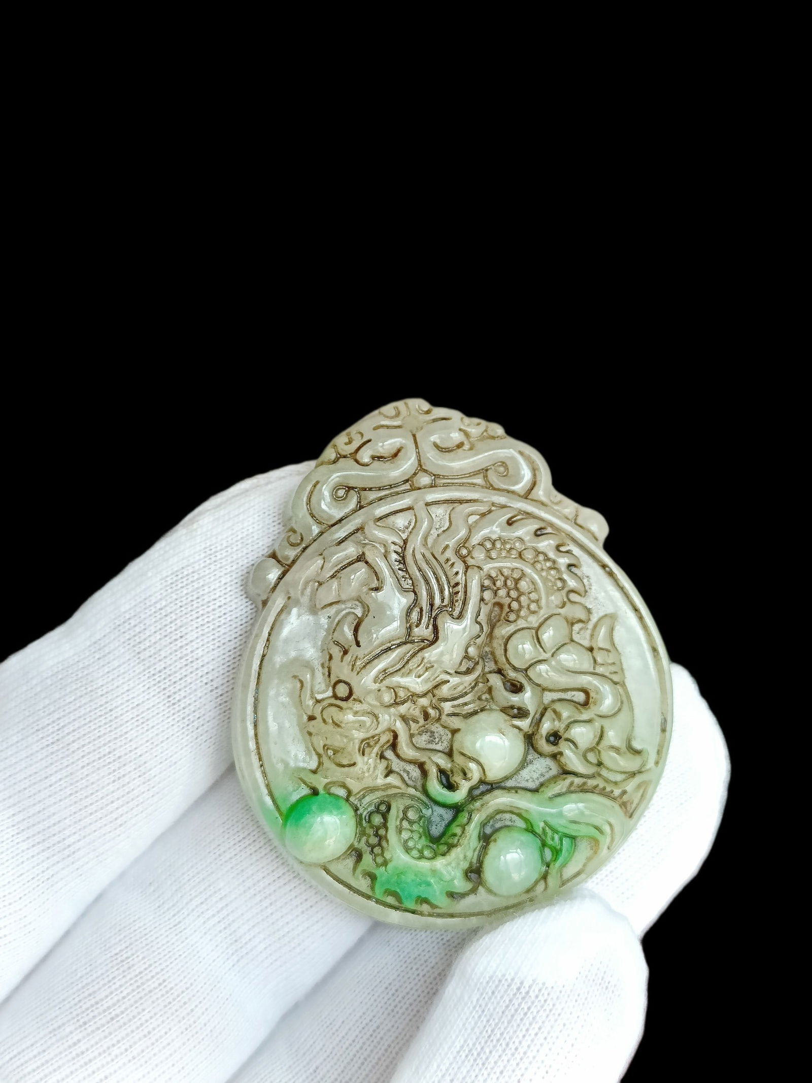 Qing Dynasty Jade Dragon Pendant with Floating Flower Design: The Qing Dynasty jade dragon pendant with floating floral patterns is exquisitely carved and in perfect condition. Provenance:Private collection, Brussels, Belgium. Our cooperative logistics services