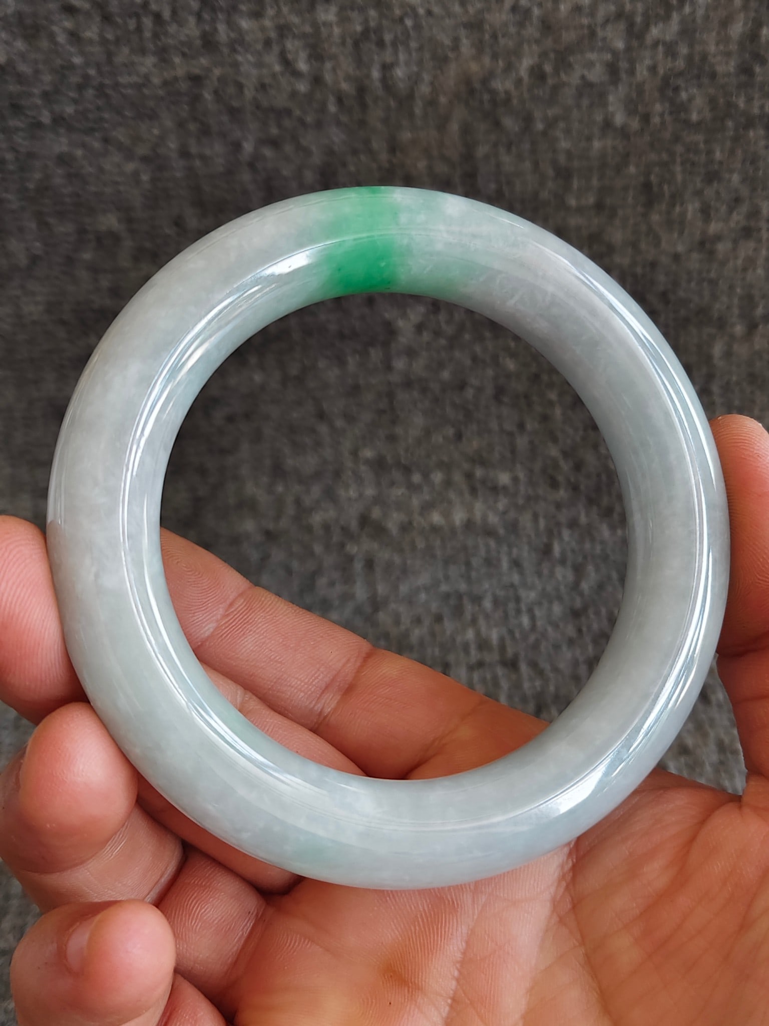 Old Collection of Qing Dynasty Jadeite Bangle with Floating Flower Pattern: This old Qing dynasty jadeite bangle features a warm and lustrous texture with a touch of vibrant green that is both lively and graceful, resembling willow branches in spring or ripples on a lake. It