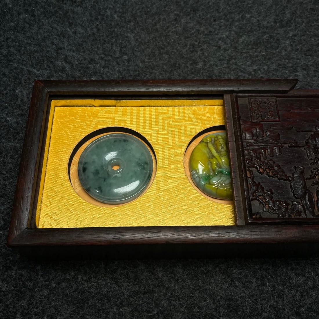 A jade pendant is placed inside a rosewood carved collection box. (1 of 9)