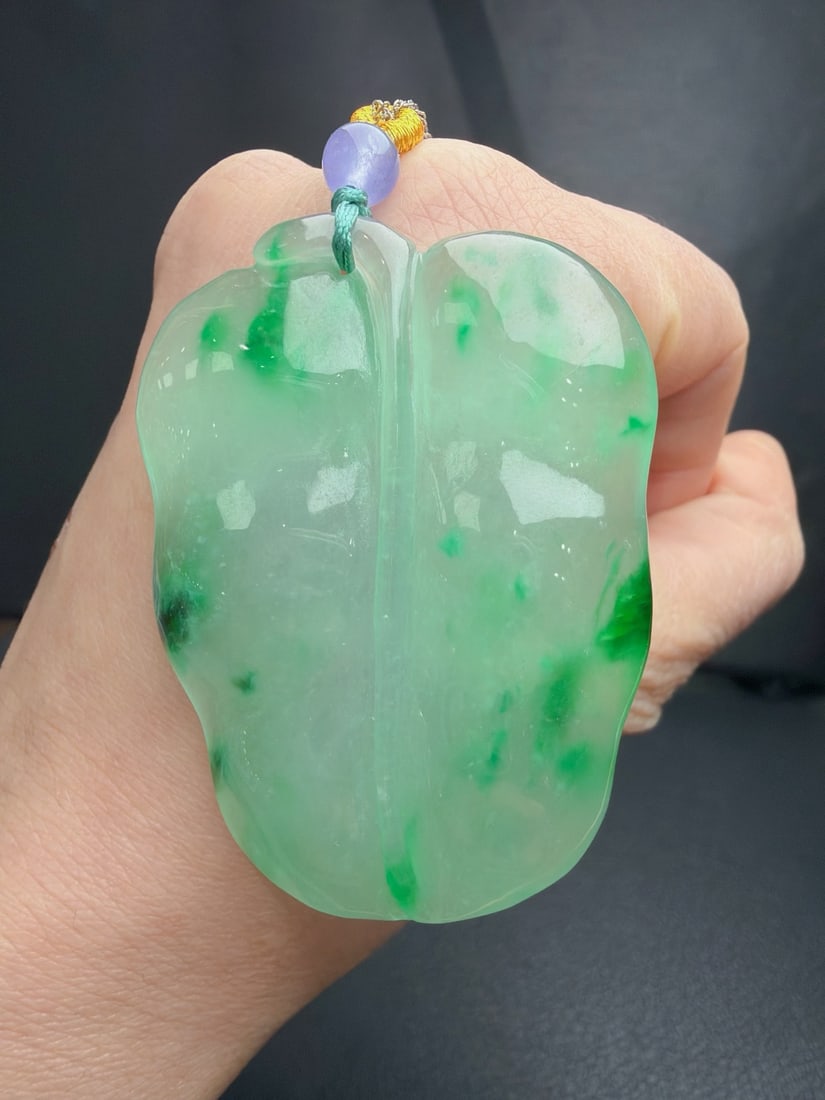 jadeite leaf pattern of icy texture with floating green leaves symbolizes "successful career.": The jadeite leaf carving, made of icy green with floating green hues, symbolizes "successful career." It is translucent and lustrous, finely carved, three-dimensional and full, with excellent texture