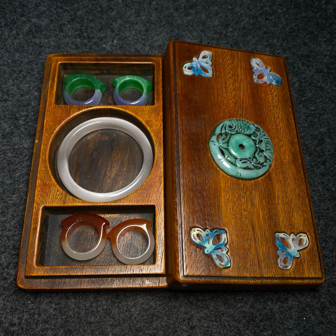 rosewood box inlaid with jade contains a cat's-eye stone bracelet and a jade ring. (1 of 9)