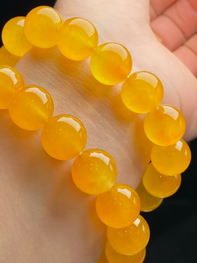 Jadeite icy yellow jadeite "bracelet": The jadeite and yellow jadeite bracelet is icy and translucent, with each bead round and full. Provenance:Private collection, Athens, Greece. Our cooperative logistics services provider expertly handl