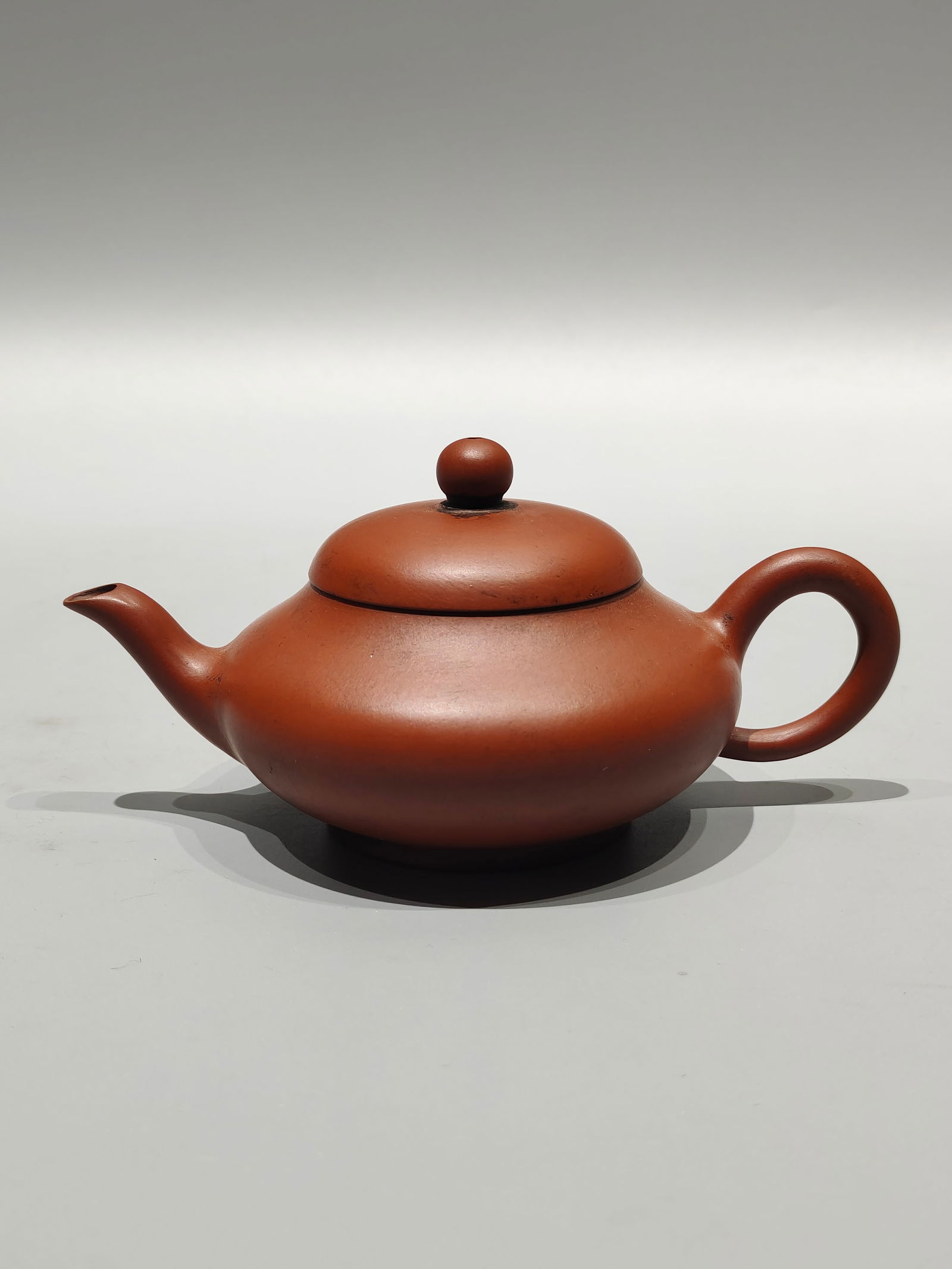 A treasured antique purple clay teapot, featuring a small piece titled "Qingjiang Yue Jinren, (1 of 7)