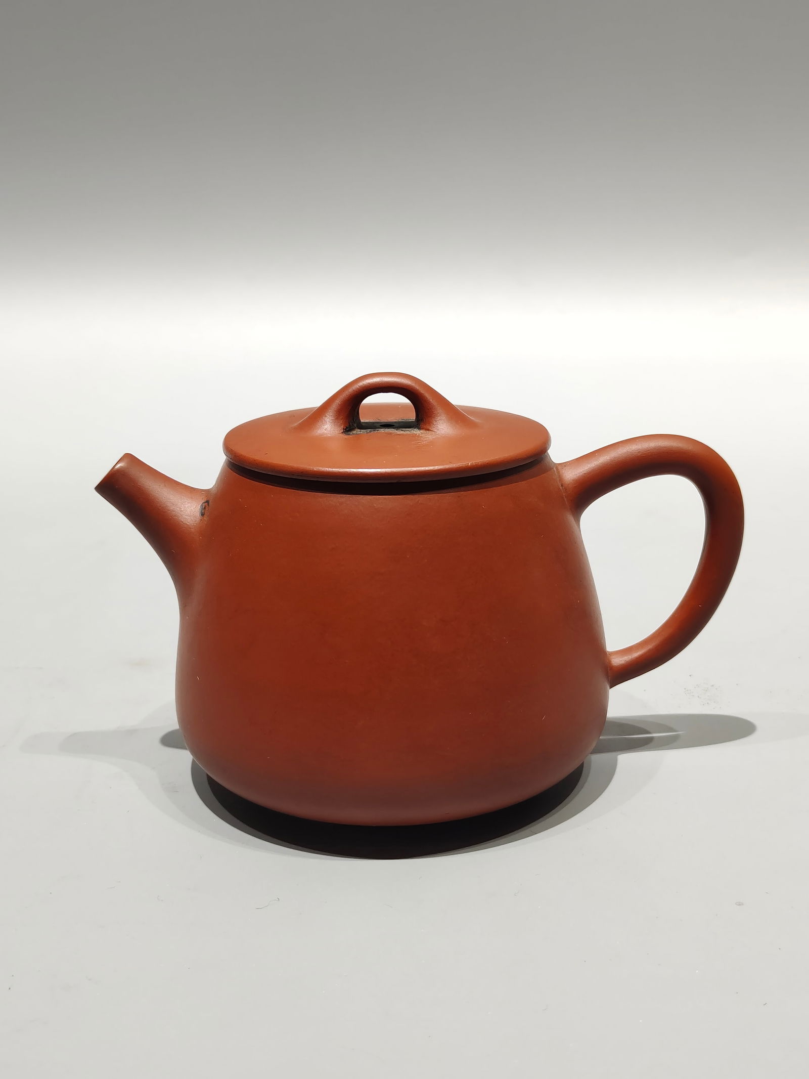 A treasured antique purple clay teapot, featuring a small painting titled "The Lake in August is (1 of 7)