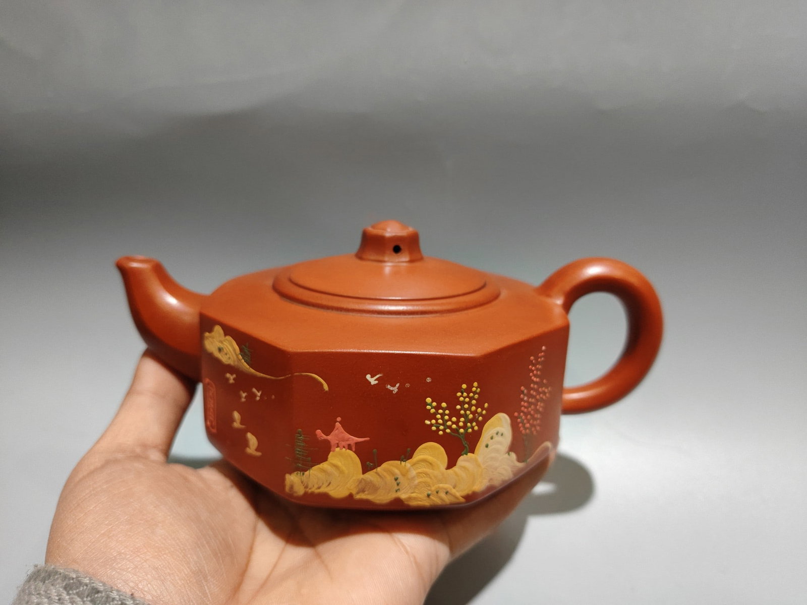 Product Name: Octagonal Clay Painting Teapot: Product Name: Octagonal Clay Painting Teapot; Bottom Mark: Gu Jingzhou; Size: 19 x 9 cm; Capacity: 400cc; Clay: Original Ore Red Clay Provenance:Private collection, Hamburg, Germany. Our cooperative l