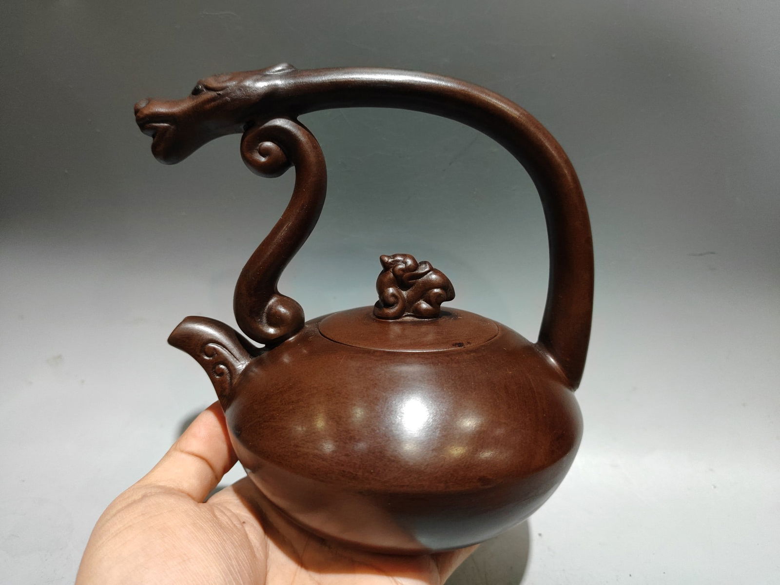 Product Name: Dragon Head Teapot with Handle: Product Name: Dragon Head Teapot with Handle; Bottom Mark: Cao Hongxi; Size: 16X15cm; Capacity: 320cc; Clay: Original Old Purple Clay Provenance:Private collection, Warsaw , Poland. Our cooperative lo