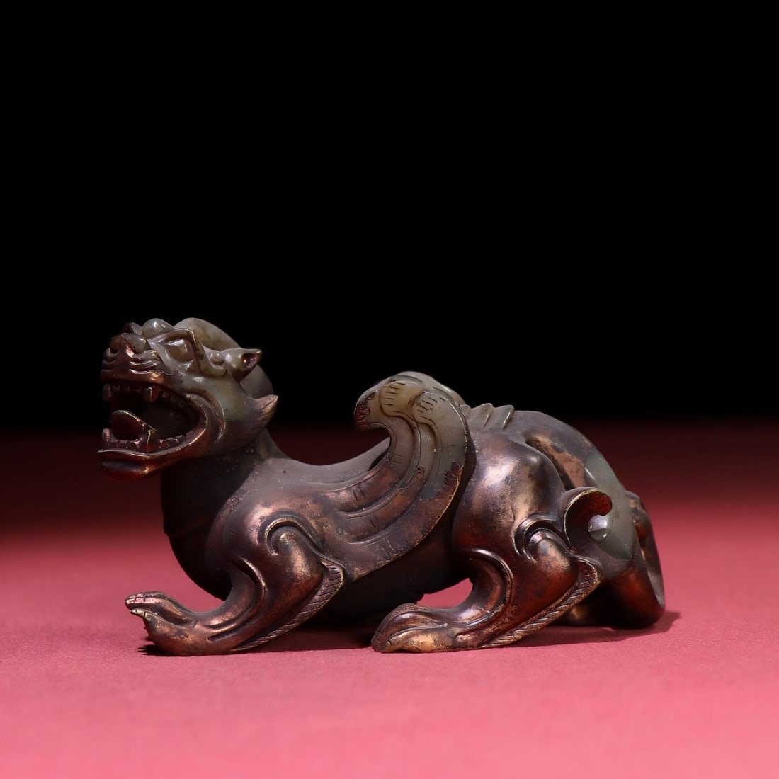 Exquisite gilded auspicious beast from a rare collection: Exquisite antique, gilded auspicious beast, with a thick patina and deep, penetrating color; superb craftsmanship and sharp carving; a rare and exceptional piece from a private collection. Provenance: