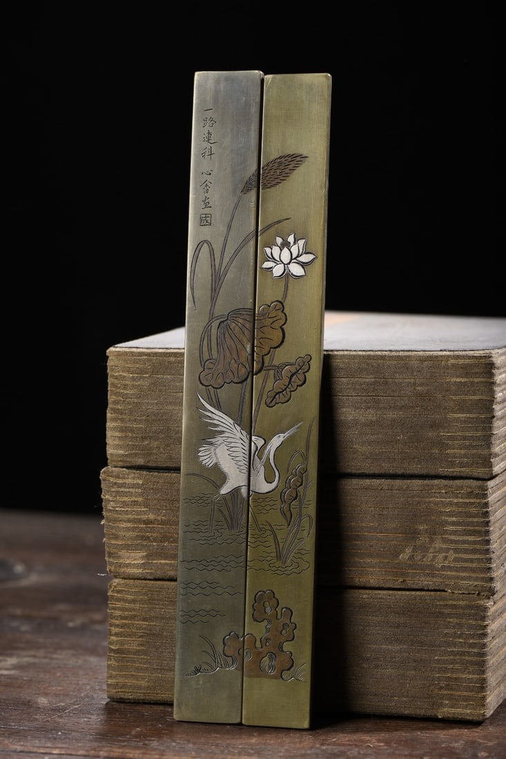 A pair of white copper gilded paperweights with the inscription "One Road to Success in (1 of 9)