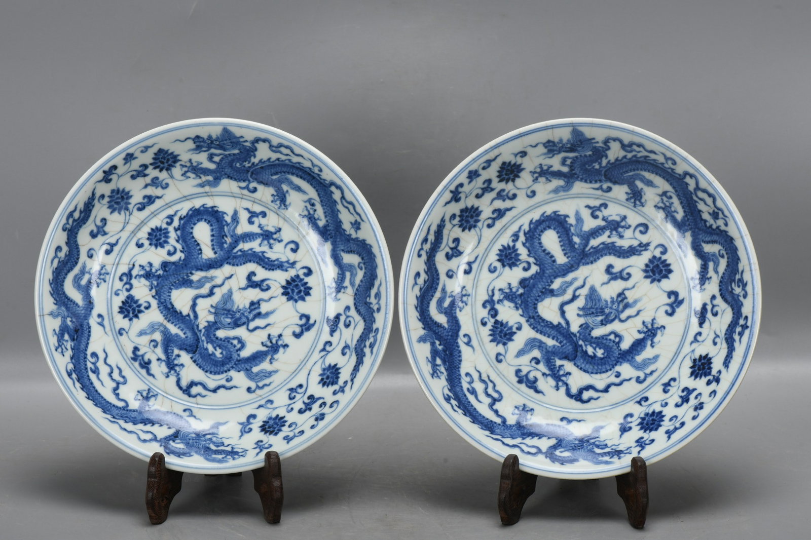 A pair of Ming Dynasty Xuande blue and white porcelain plates with lotus scrolls and five dragons. (1 of 9)