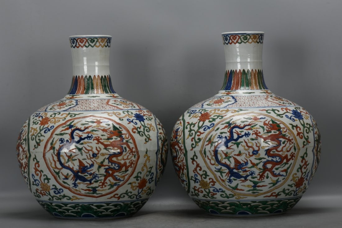 A pair of Ming Dynasty, Zhengde period, polychrome celestial globe vases with dragon and wave: A pair of polychrome celestial globe vases with dragon and wave patterns from the Zhengde period of the Ming Dynasty. They are 41.5 cm high, 9.7 cm in diameter at the mouth, 34.5 cm in diameter at the