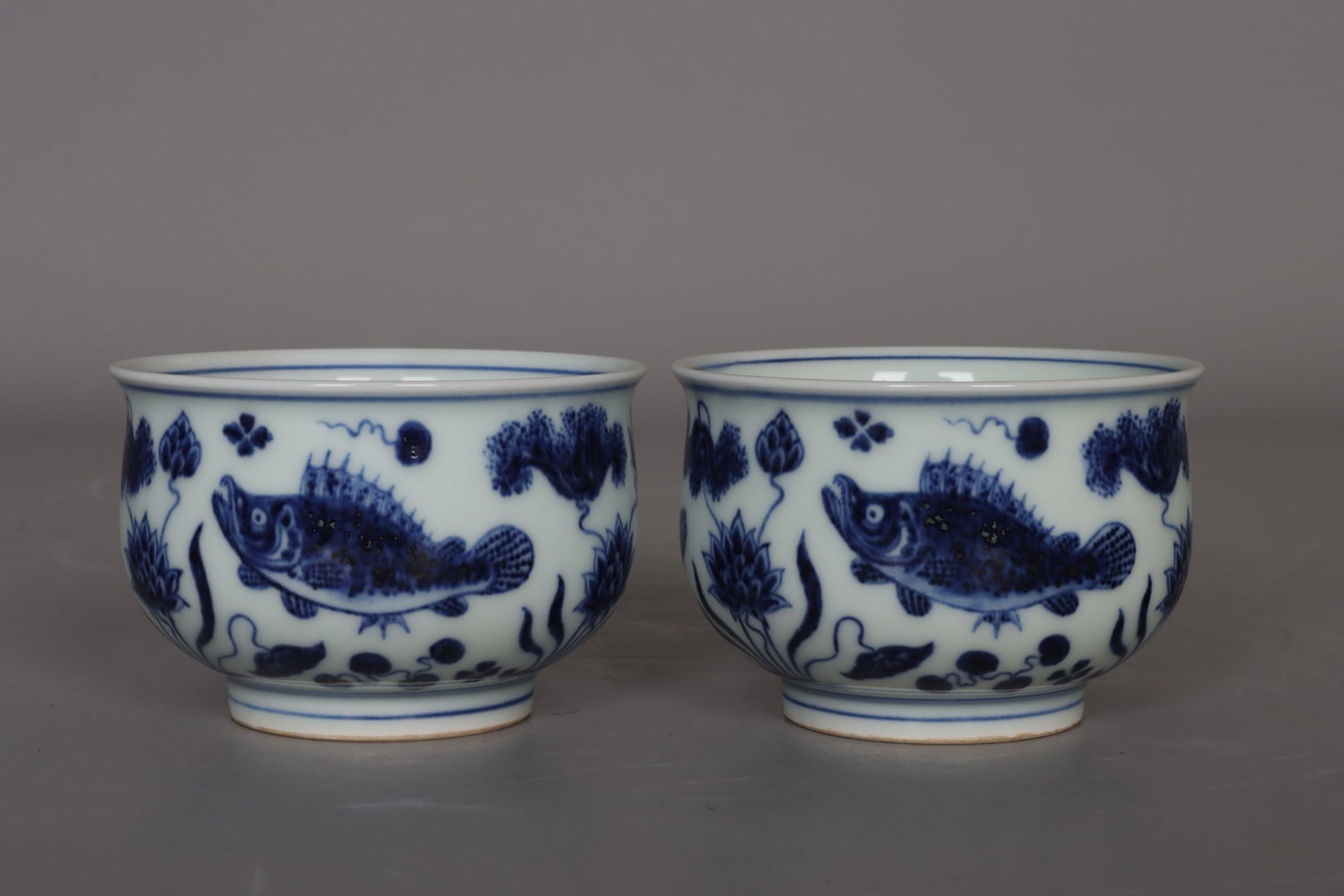 A pair of Ming and Xuande blue and white fish and grass cups (1 of 9)