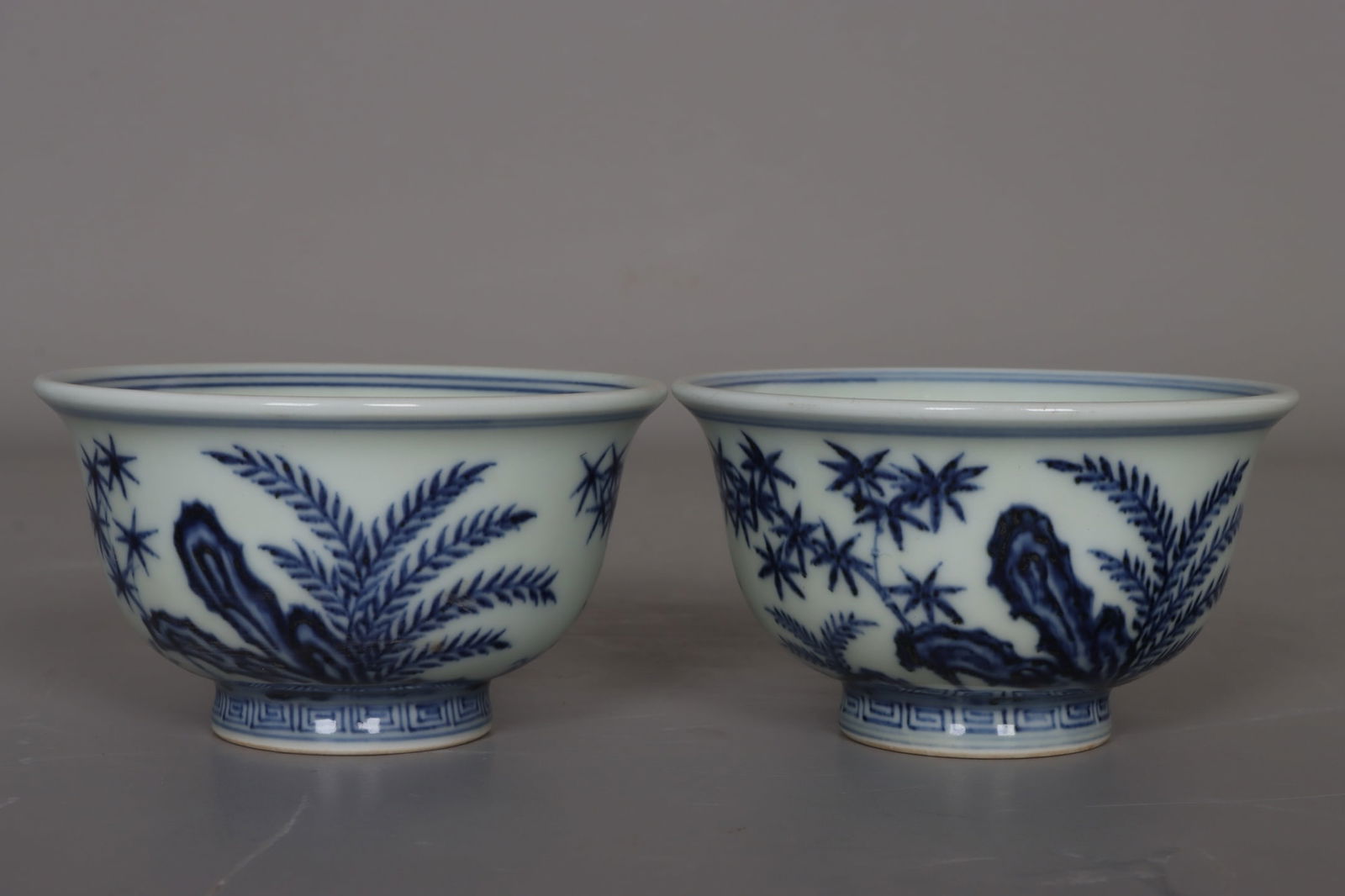A pair of Ming and Xuande blue and white bamboo, rock and grass cups (1 of 9)