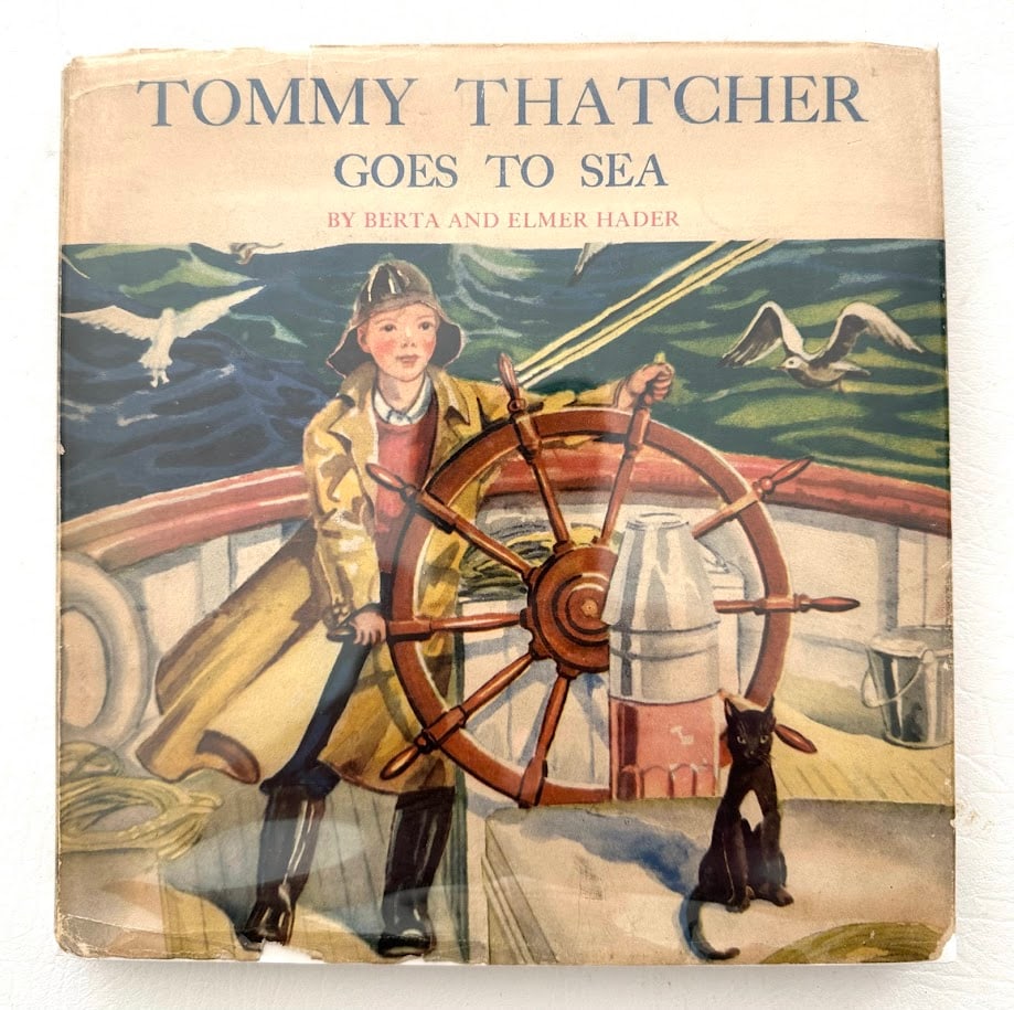 Berta & Elmer Hader. Tommy Thatcher Goes to Sea.: New York: 1937. With numerous color and b/w illustrations by the Haders; first edition. Verso of the front fly leaf with a full page original watercolor, inscribed and SIGNED by the Haders. Covers