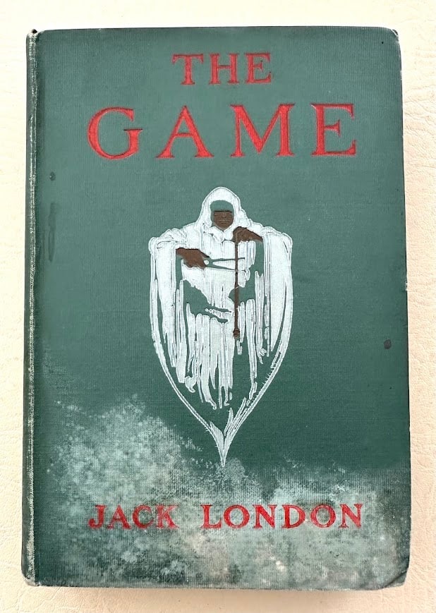 The Game. Jack London. First edition.: New York: 1905. 8vo; 182pp; decorative cloth; illustrated. Covers damp stained and lightly rubbed; end papers, fly leaves, and lower portion of text also slightly damp stained. First edition, second