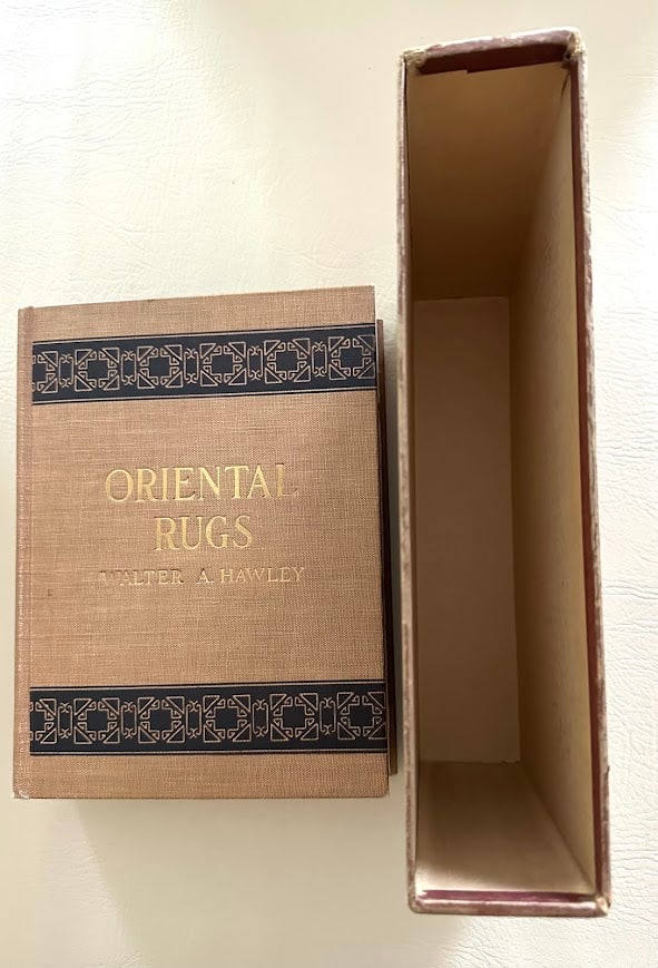 Oriental Rugs. Antique and Modern, by Walter Hawley.: New York: 1937. 4to; 320pp; gilt decorative cloth; illustrated with a foldout color frontispiece plus nmerous photographic images; covers lightly faded; book slightly loose in binding due to thickness