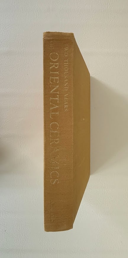 Two Thousand Years of Oriental Ceramics, by Fujio Koyama.: New York: 1960. Small folio; 379pp; cloth; with 173 illustrations, including 54 tipped in color plates; covers lightly rubbed and faded; front inner hinge starting, otherwise very good.