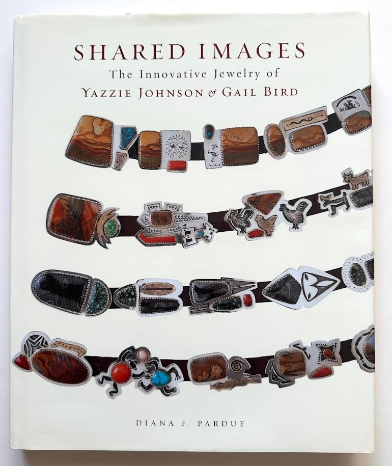 Diana F. Pardue. Shared Images. The Innovative Jewelry of Yazzie Johnson & Gail Bird.: Phoenix: Heard Museum, 2007. 4to; 187pp; gilt lettered cloth; decorative jacket; profusely illustrated with color photographs. First edition. SIGNED by Yazzie Johnson, Gail Bird, and Diana Bird; laid 