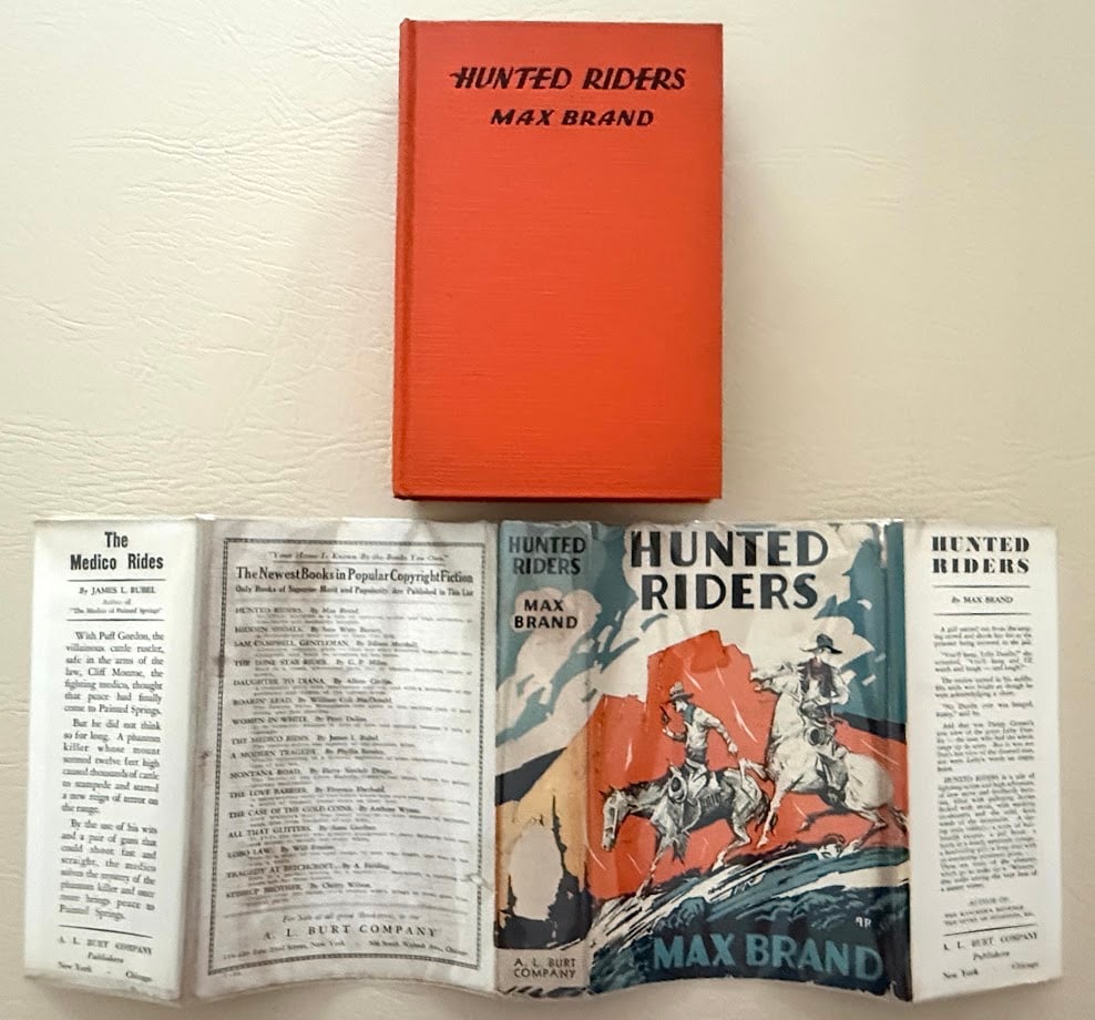 Max Brand. Hunted Riders.: Chicago: A.L. Burt, circa 1930's. 8vo; 300pp; lettered cloth; color pictorial jacket; inked signature front end paper with small abrasion; jacket with minimal wear to edges, otherwise jacket is fine.