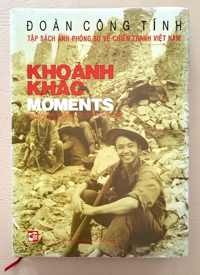 Khoanh Khac Moments. Photograph Material on the Vietnam War, by Doan Cong Tinh.: Ho Chi Minh: 2005. 4to; 176pp; boards; color pictorial jacket; illustrated throughtout with photographs; fine copy. Probable first edition. A photographic record of the Vietnam War by photo journalist
