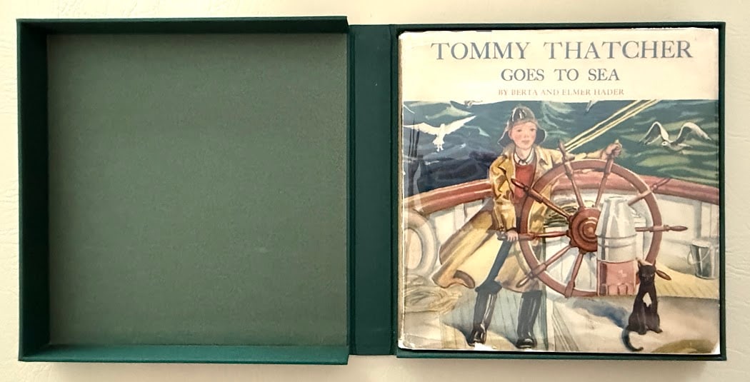 Berta & Elmer Hader. Tommy Thatcher Goes to Sea.: New York: 1937. Square 4to; 96pp; gilt pictorial cloth; color pictorial jacket; with numerous color and b/w illustrations by the Haders; covers lightly faded and rubbed; pictorial jacket slightly chip
