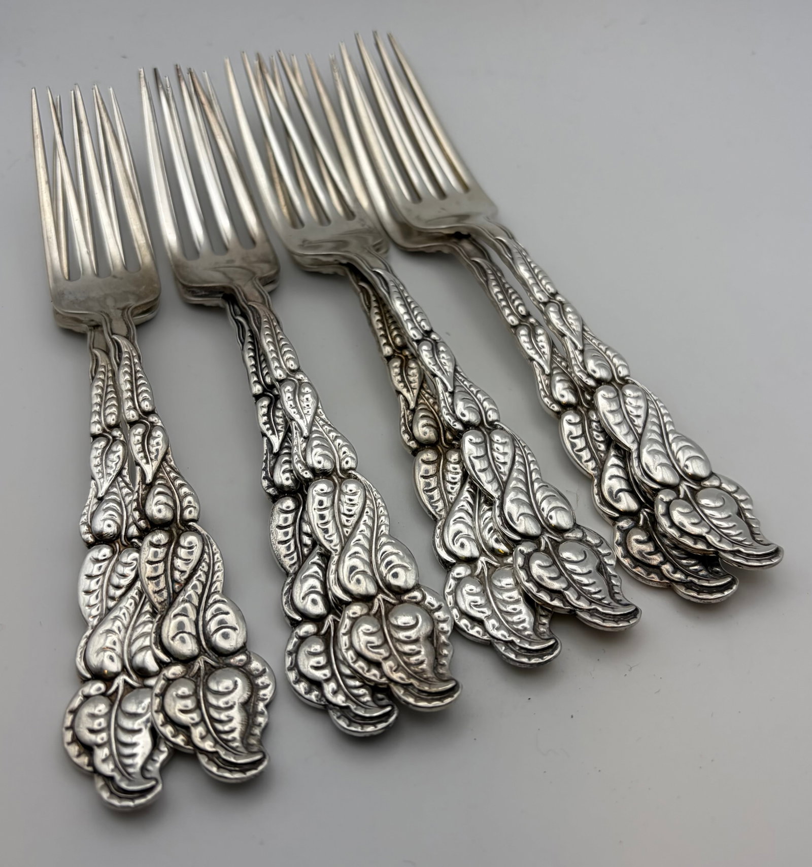 Eight Tiffany Atlantis-Ailanthus Sterling Silver Forks: A set of eight Tiffany & Co sterling silver forks. Each has a subtile ‘D’ monogram on the back. The set weighs a total of 415.63 grams with each fork weighing slightly different between 53