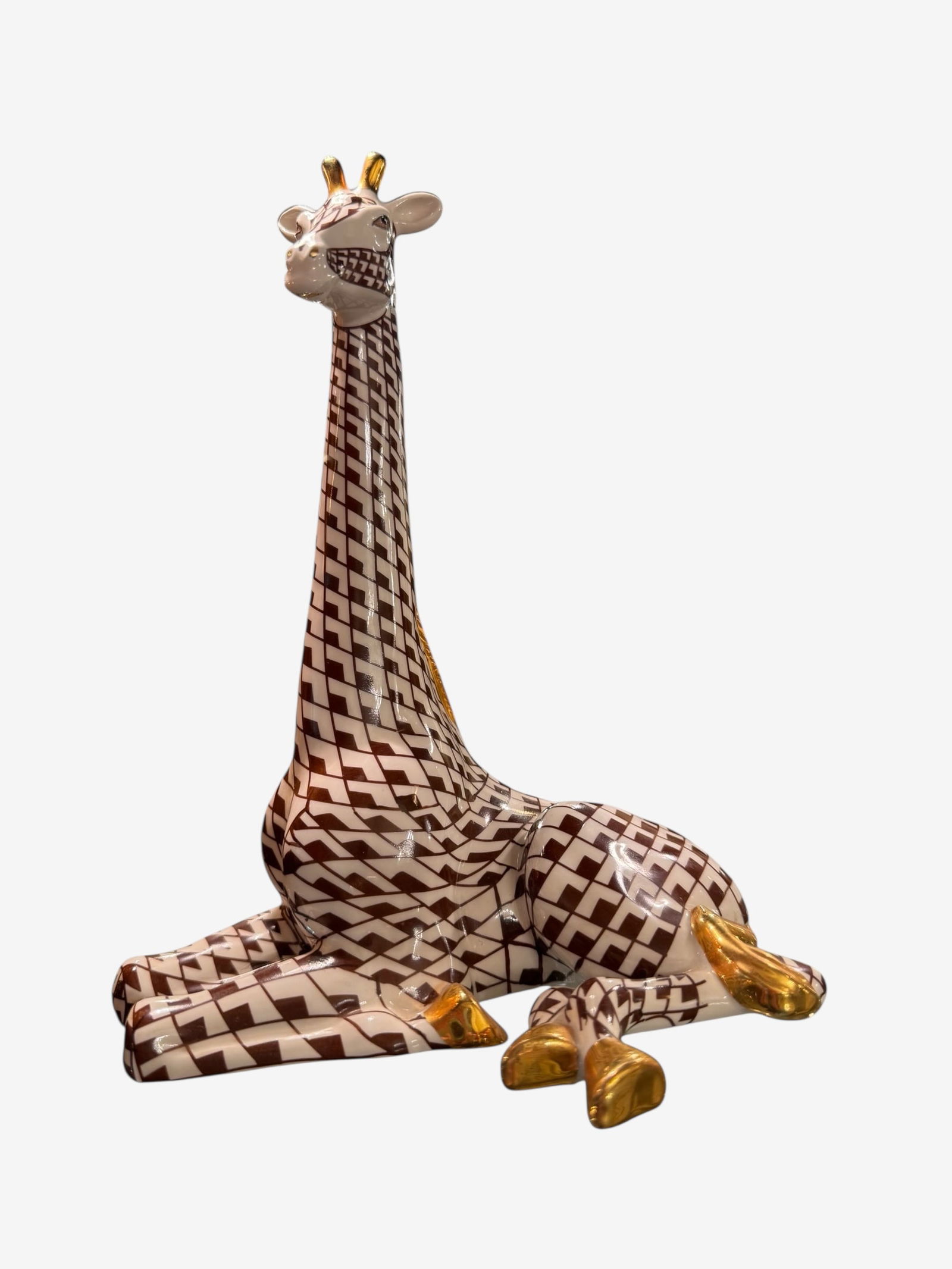 Herend porcelain Brown Geometric Giraffe Figurine: Herend reclining giraffe figurine with brown/white checkered pattern and gold accents. Marked "? 2004".