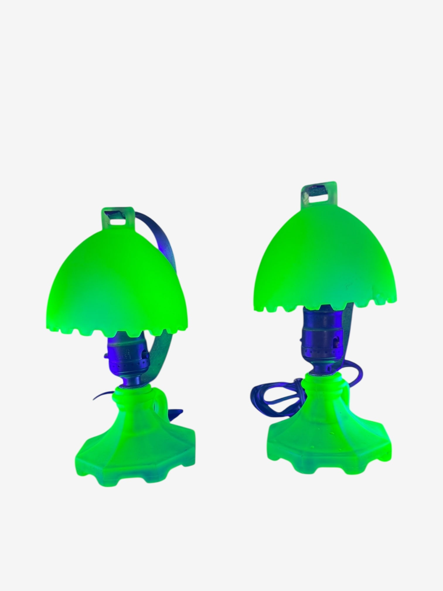 Vintage Uranium glass boudoir lamps.: Vintage green Uranium glass lamps. Both working. One shade is perfect, no chips. The other has 3-4 small chips on the sawtooth edge. Both bases in perfect condition.