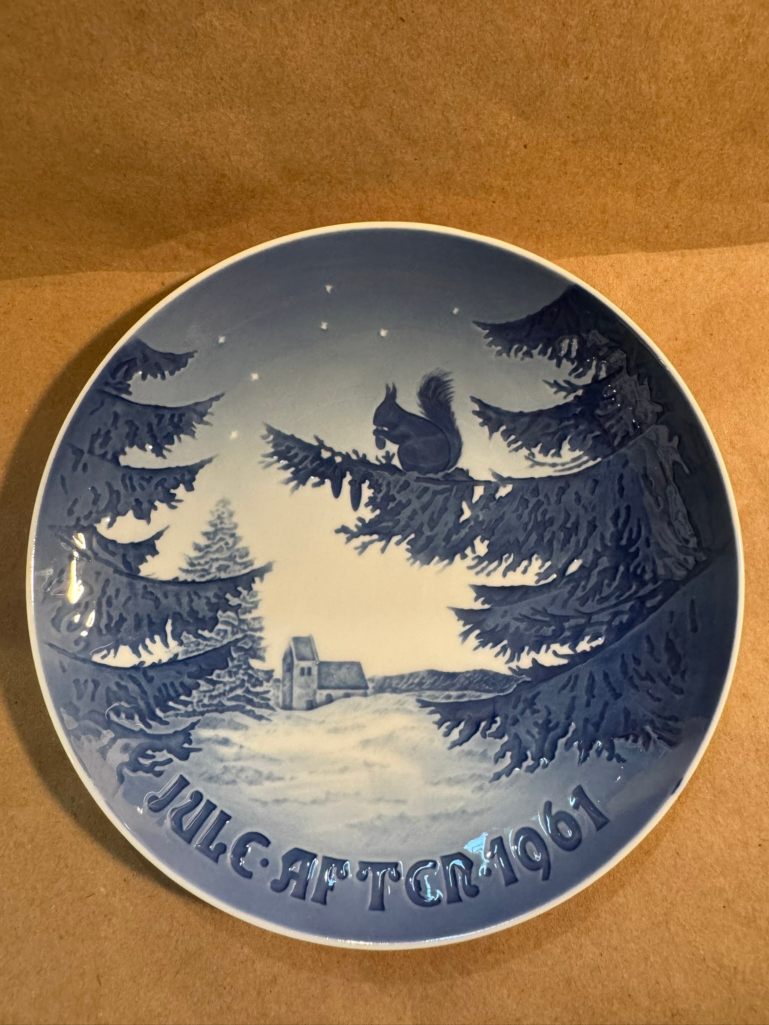1961 - Winter Harmony: Up for auction is a pristine Bing & Grondahl Christmas Plate titled '1961 - Winter Harmony'. This exquisite collector's item was originally issued in the year 1961. Featuring the manufacturer's