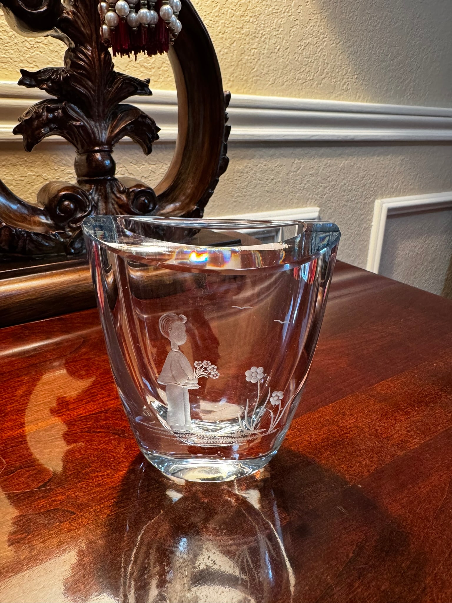 Strombergshyttan Swedish Etched Vase - Girl & Flowers: An elegant and heavy clear crystal art glass vase by Strombergshyttan, Sweden. Features a detailed intaglio (etched/engraved) design depicting a young girl sitting and holding a bunch of flowers.