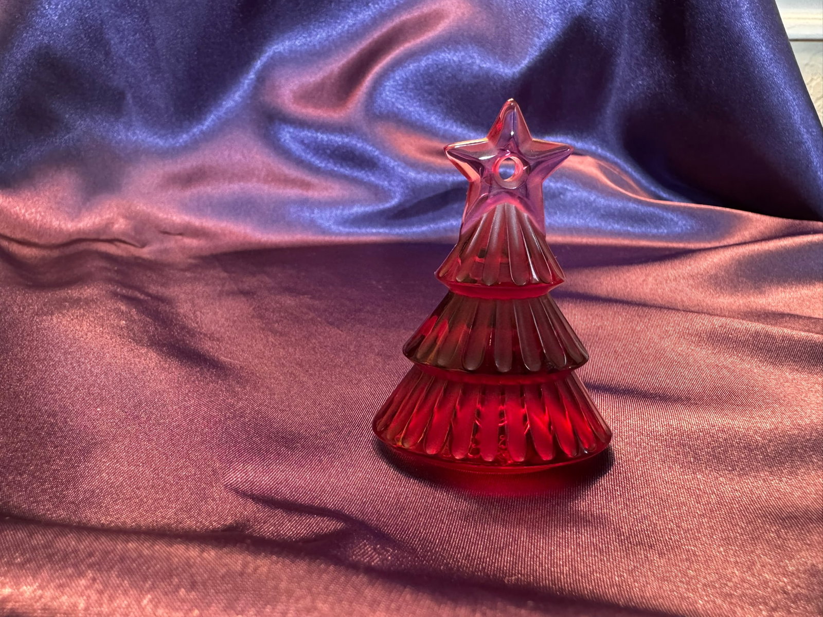 Lalique Ruby Red Crystal Christmas Tree: Elegant Lalique France ruby red crystal Christmas tree ornament. Features tiered, textured branches topped with a classic star.