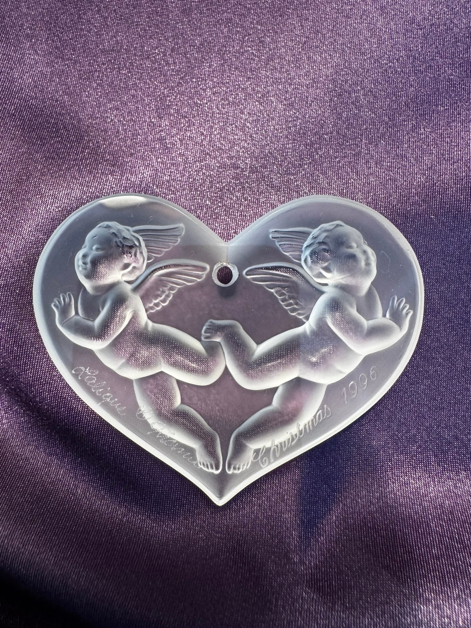 Lalique 1996 Heart Cherub Christmas Ornament: A beautiful 1996 annual Lalique France frosted crystal Christmas ornament in a heart shape, depicting two cherubs in high relief. Signed and dated.