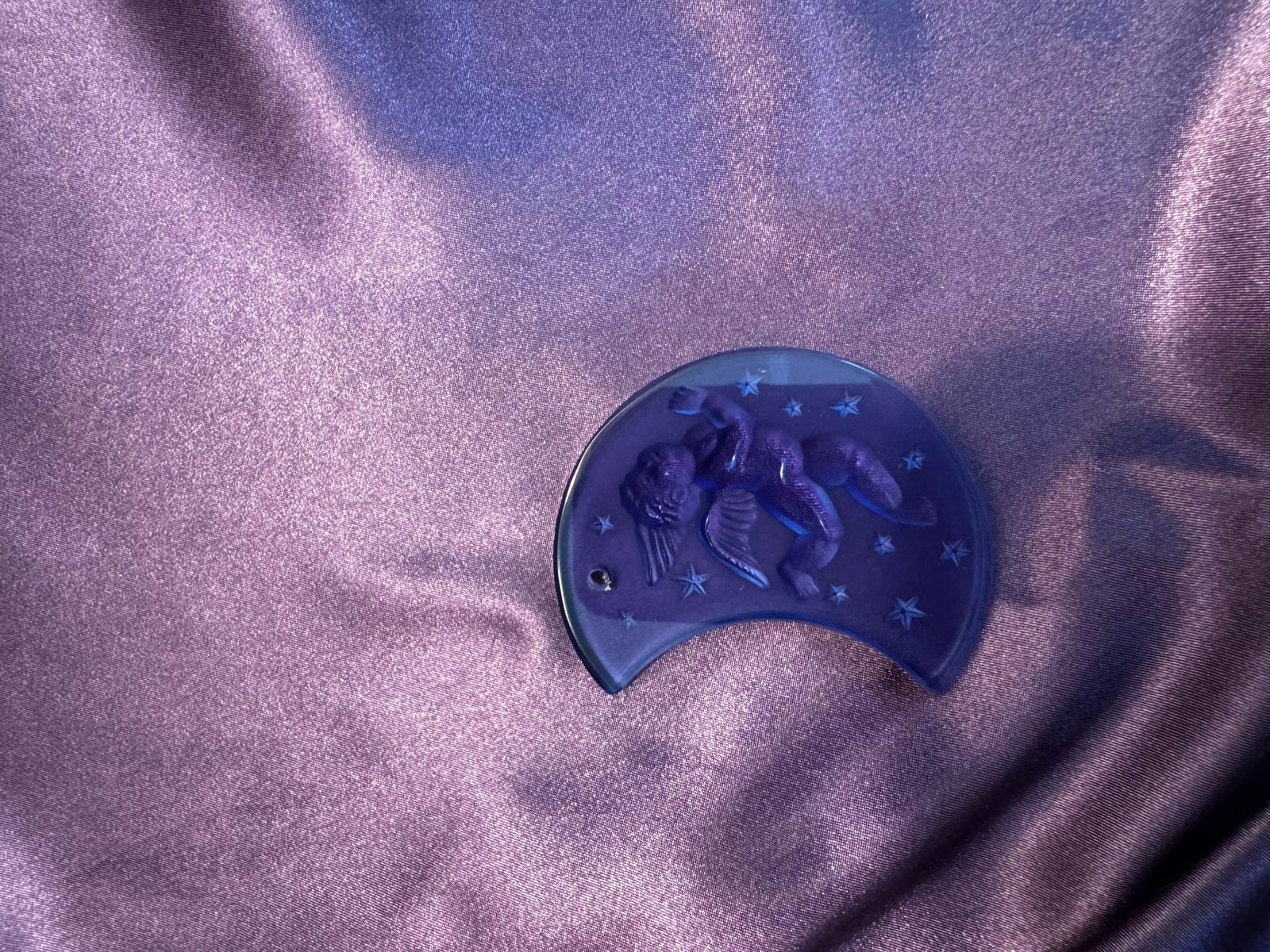 Lalique Blue Crystal Cherub on Moon Ornament 1999: A striking Lalique France deep blue colored crystal holiday ornament featuring a frosted cherub resting peacefully on a crescent moon surrounded by stars.