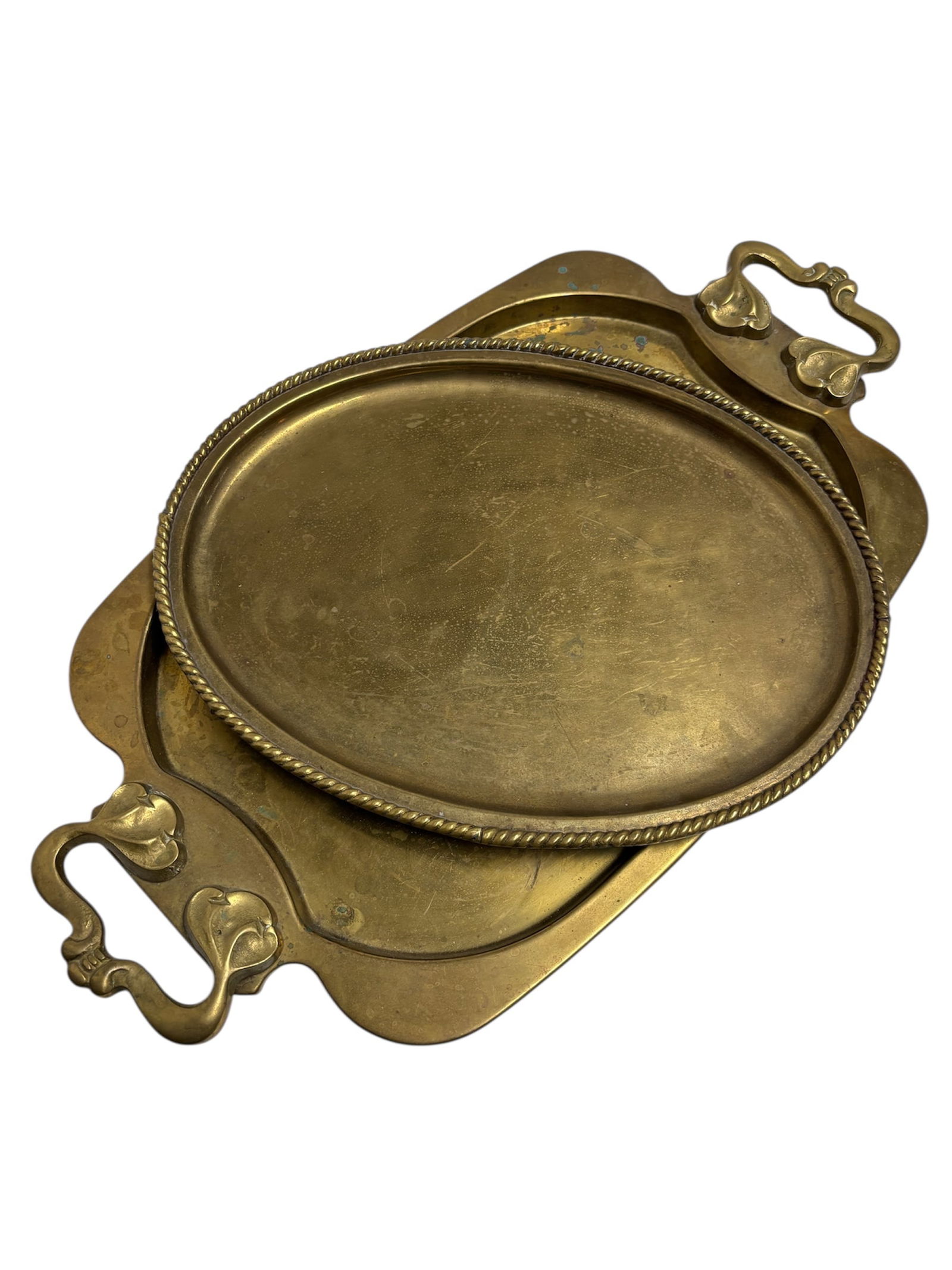 Vintage & Art Nouveau Style Brass Trays: This vintage brass serving tray with double handles in an Art Nouveau style with raised ornate scroll design on handles in heavy brass (well worn). Also included distinctive twisted rope rim oval tray